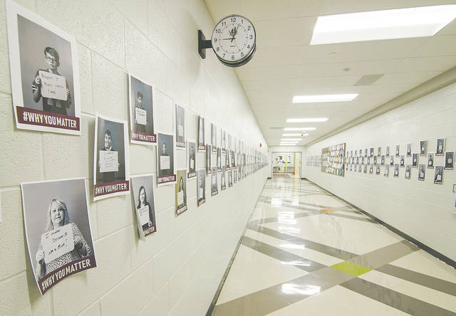 The main hallway at Urbana Junior High School is lined with individual images of students expressing why they matter to someone.